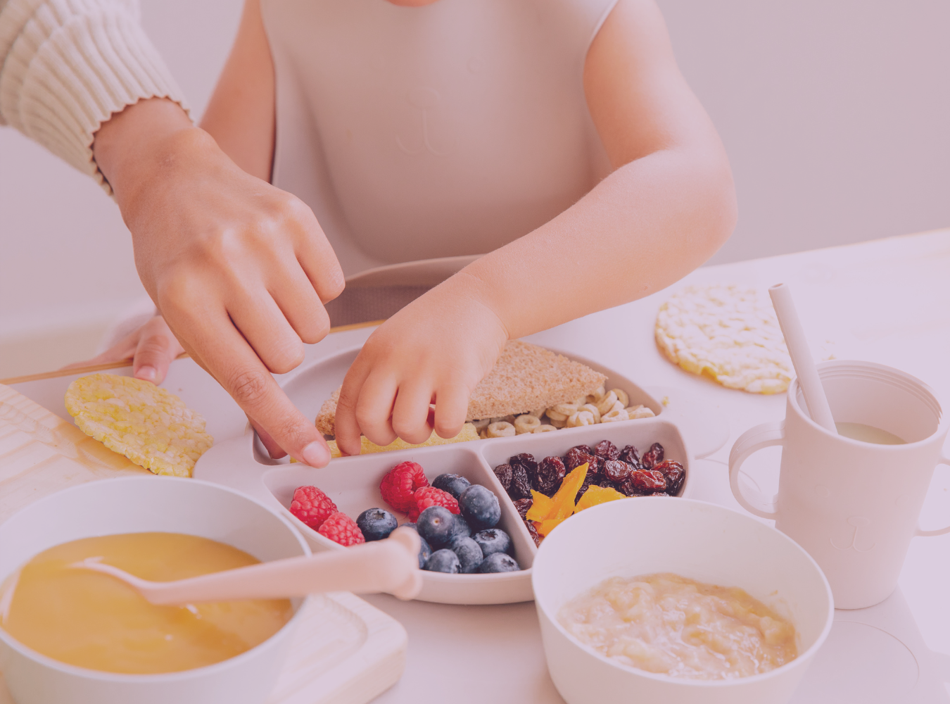 Parent and toddler selecting healthy finger foods as part of early weaning and baby-led feeding