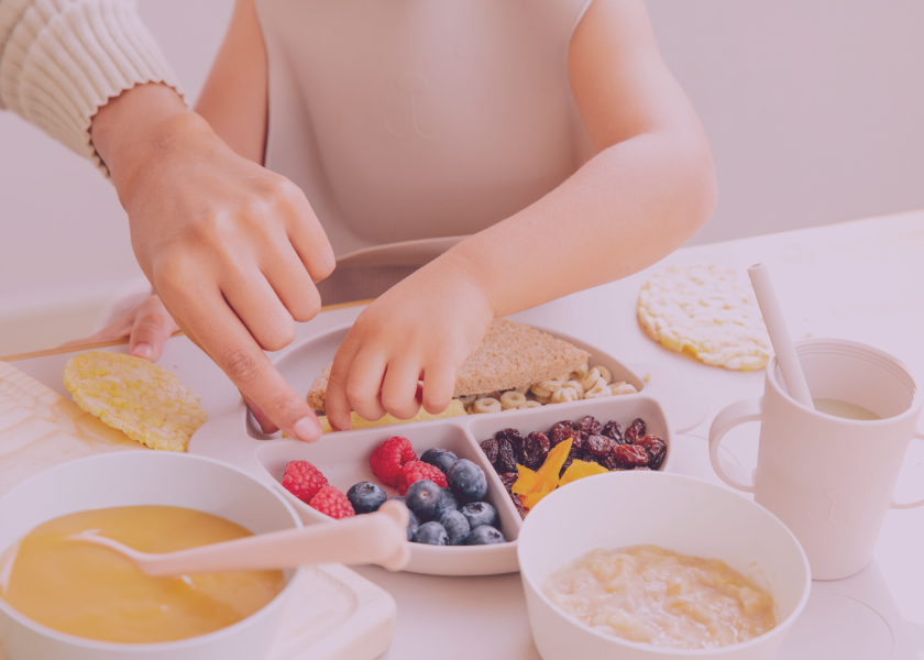 Parent and toddler selecting healthy finger foods as part of early weaning and baby-led feeding