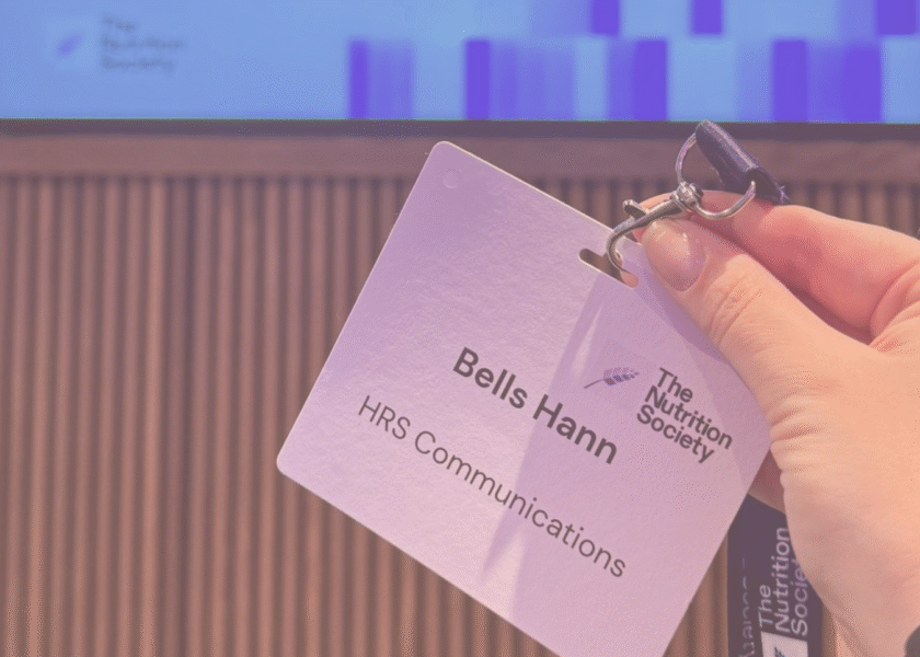 Bells hand holding her name badge at the event