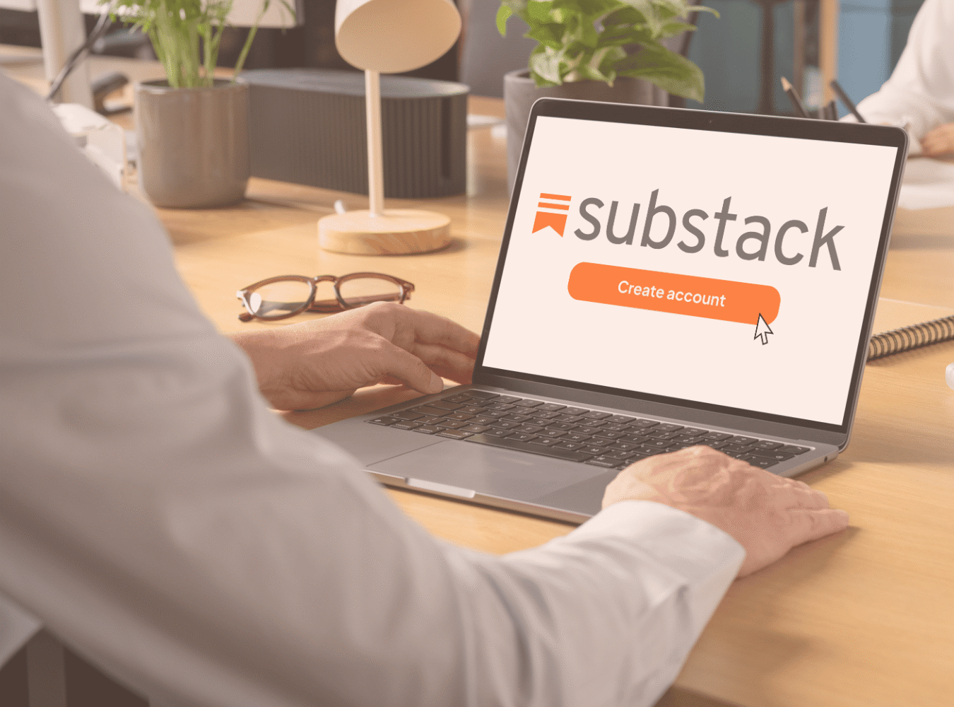 Person looking at laptop screen contemplating whether to create a Substack account